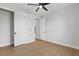 Clean bedroom with a ceiling fan, wood-look floors, and white trim with a closet and doorway visible at 8105 Antwerp Cir, Port Charlotte, FL 33981