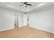 Spacious bedroom with wood floors, ensuite access, and neutral walls at 8105 Antwerp Cir, Port Charlotte, FL 33981