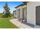 A paved walkway leads to a modern, stylish home with a two-car garage at 8105 Antwerp Cir, Port Charlotte, FL 33981