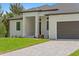 This home has a paved driveway leading to a modern two-car garage and covered front entrance at 8105 Antwerp Cir, Port Charlotte, FL 33981