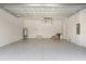 Spacious two car garage with epoxy floor, white walls, and ample room for vehicles and storage at 8105 Antwerp Cir, Port Charlotte, FL 33981