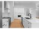 A bright kitchen featuring white cabinetry and countertops and stainless steel appliances at 8105 Antwerp Cir, Port Charlotte, FL 33981