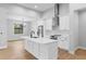 A bright, white kitchen with stainless steel appliances and a large center island at 8105 Antwerp Cir, Port Charlotte, FL 33981