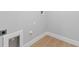 A well-lit laundry area showing hookups and stylish light wood-look flooring with clean, modern trim at 8105 Antwerp Cir, Port Charlotte, FL 33981