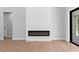 Modern living room with a sleek electric fireplace and wood-look flooring at 8105 Antwerp Cir, Port Charlotte, FL 33981