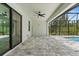 Spacious outdoor patio area with tiled floors leading to a screened-in pool at 8105 Antwerp Cir, Port Charlotte, FL 33981