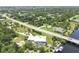 Aerial view of a home with a private pool, a boat dock, and surrounded by lush greenery and waterways at 8127 Consul St, Port Charlotte, FL 33981