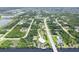 Aerial view showcasing a property with a pool and boat dock amidst a lush, waterfront community at 8127 Consul St, Port Charlotte, FL 33981