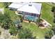 Aerial view of a home with screened pool, lush landscaping, a fire pit, and outdoor seating at 8127 Consul St, Port Charlotte, FL 33981