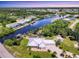 Stunning aerial view of waterfront home with pool, lush landscaping, boat dock and seawall at 8127 Consul St, Port Charlotte, FL 33981