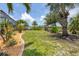 Serene backyard showcasing lush landscaping and a canal view beyond the yard at 8127 Consul St, Port Charlotte, FL 33981