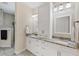 Bathroom with dual sinks, granite countertops, and a large cabinet offers elegance and functionality at 8127 Consul St, Port Charlotte, FL 33981