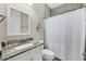 Cozy bathroom with granite countertop vanity and white shower curtain at 8127 Consul St, Port Charlotte, FL 33981