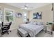 Cozy bedroom features two bright windows, a ceiling fan, and a stylish desk area, blending comfort and function at 8127 Consul St, Port Charlotte, FL 33981