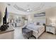 Well-lit bedroom boasts a tray ceiling, fan, and decorative vanity area offering comfort and style at 8127 Consul St, Port Charlotte, FL 33981