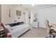 Comfortable bedroom featuring wood floors, nautical decor, and a study space at 8127 Consul St, Port Charlotte, FL 33981