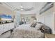 Bright bedroom with tray ceiling, fan, vanity, and ample natural light creates a serene and stylish retreat at 8127 Consul St, Port Charlotte, FL 33981
