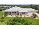 Charming home with a metal roof, inviting front porch, and meticulously landscaped front yard at 8127 Consul St, Port Charlotte, FL 33981