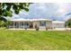 Beautiful single-Gathering home with a welcoming porch, blue shutters, and lush green lawn at 8127 Consul St, Port Charlotte, FL 33981