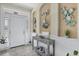 Welcoming foyer with neutral walls, decorative artwork, and a stylish console table at 8127 Consul St, Port Charlotte, FL 33981
