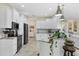 Bright kitchen featuring white cabinets, granite countertops, and stainless steel appliances at 8127 Consul St, Port Charlotte, FL 33981