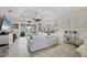 Bright living room with tile floors, tray ceiling, and sliding doors to the pool at 8127 Consul St, Port Charlotte, FL 33981