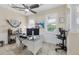 Home office featuring a ceiling fan, tiled floors, and plantation shutters for a bright and functional workspace at 8127 Consul St, Port Charlotte, FL 33981