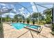 Beautiful screened-in pool and spa area, surrounded by palm trees and greenery at 8127 Consul St, Port Charlotte, FL 33981