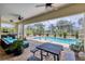 Relaxing screened-in pool area with comfortable seating and a dining table at 8127 Consul St, Port Charlotte, FL 33981