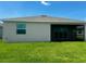 A backyard with a covered patio and grassy lawn at 8360 Waterscape Rd, Englewood, FL 34224