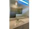 Bathroom features a long vanity with dual sinks, large mirror, and a glass-enclosed shower at 8360 Waterscape Rd, Englewood, FL 34224