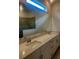 Bathroom features a long vanity with dual sinks, large mirror, and a glass-enclosed shower at 8360 Waterscape Rd, Englewood, FL 34224