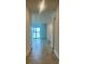 Bright hallway featuring light tile floors and a view of the lake at 8360 Waterscape Rd, Englewood, FL 34224