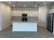 Spacious kitchen featuring a center island, modern appliances, and ample countertop space at 8360 Waterscape Rd, Englewood, FL 34224