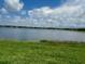 Beautiful lake view homesite with lush green grass and stunning waterfront views from the backyard at 8360 Waterscape Rd, Englewood, FL 34224