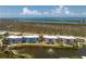 Condo community with beautiful landscaping, lake with fountain, and ocean views from upper floors at 8405 Placida Rd # 406, Placida, FL 33946
