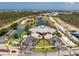 Wide aerial shot showcasing the community amenities including tennis courts and waterfront views at 8405 Placida Rd # 406, Placida, FL 33946