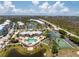 Expansive aerial view showcases the community pool, tennis courts, and scenic surroundings at 8405 Placida Rd # 406, Placida, FL 33946