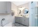 Bright primary bathroom with double sinks, vessel sinks, and glass-enclosed shower at 8405 Placida Rd # 406, Placida, FL 33946