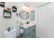 Powder blue bathroom with a mirror, lighting and decorative art at 8405 Placida Rd # 406, Placida, FL 33946