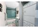 Bathroom with blue subway tile shower, laundry machines, sink and toilet at 8405 Placida Rd # 406, Placida, FL 33946