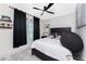 Bright bedroom featuring a ceiling fan, a window with black curtains and stylish decor at 8405 Placida Rd # 406, Placida, FL 33946