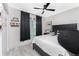 Bright bedroom featuring a ceiling fan, a window with black curtains and stylish decor at 8405 Placida Rd # 406, Placida, FL 33946