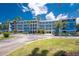 Condominium complex with lush landscaping and beautiful sky at 8405 Placida Rd # 406, Placida, FL 33946
