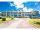 This condo community features a blue color scheme, covered parking, and well maintained landscaping at 8405 Placida Rd # 406, Placida, FL 33946