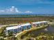 Scenic view of a condo complex overlooking the water with lush landscaping at 8405 Placida Rd # 406, Placida, FL 33946
