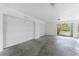 Spacious two-car garage with white doors, concrete floor and a clear exit at 8405 Placida Rd # 406, Placida, FL 33946