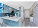 Bright kitchen with quartz countertop island, blue cabinets and backsplash with stainless steel appliances at 8405 Placida Rd # 406, Placida, FL 33946
