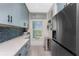 Galley kitchen with stainless steel appliances, quartz counters, and blue cabinets at 8405 Placida Rd # 406, Placida, FL 33946
