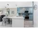 Open kitchen with stainless appliances, stylish light fixture, quartz countertop island, and seating at 8405 Placida Rd # 406, Placida, FL 33946